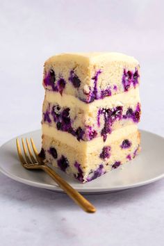 three slices of blueberry cheesecake on a plate with a fork