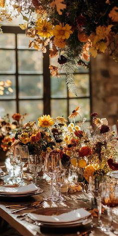 the table is set with flowers and wine glasses