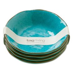 stack of blue and white bowls with tagli living logo on the bottom in front of a white background