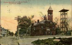 an old postcard with a clock tower in the background and trees on both sides