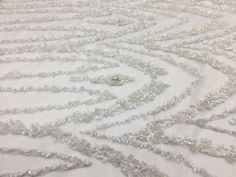 a white table cloth covered in lots of beads