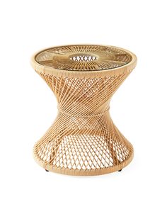 a wicker table with a glass top on the bottom and an intricate design in the middle