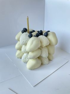 a sculpture made out of marshmallows and blueberries on a white surface