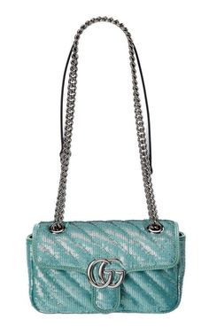 The bag is presented in pastel green with shining sequins against a satin base. The mini shoulder bag is completed by the recognizable Double G hardware.Pastel green sequin embroidered quilted silkPastel green leather trimShiny silver-toned hardwareSilk liningDouble GInternal open pocket for larger phonesSliding chain strap can be worn as a shoulder strap with 55cm drop or can be worn as a top handle with 30cm drop. Can also be worn cross body.Flap with spring closureThis item can fit a cell pho Silver Gucci Bag With Chain Strap, Green Gucci Shoulder Bag For Evening, Gucci Green Shoulder Bag For Evening, Silver Gucci Evening Bag, Luxury Gucci Green Shoulder Bag, Gucci Silver Shoulder Bag With Silver-tone Hardware, Green Evening Shoulder Bag With Silver-tone Hardware, Evening Green Shoulder Bag With Silver-tone Hardware, Designer Silver Gucci Bags