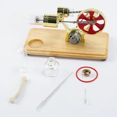 a wooden board with some tools on top of it, including a sewing machine and thread spools