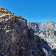 the mountains are covered in snow and rock, as seen from the top of a mountain