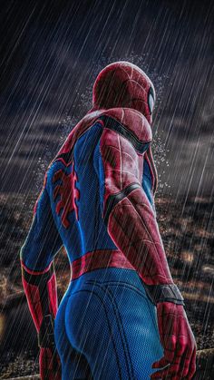 the amazing spider - man is standing in the rain