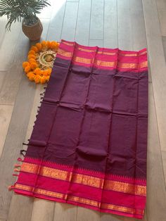 These Kanchi sarees are known for their tradition, comfort and simplicity. The saree is handwoven and comes with an intricately woven border. This saree comes in eggplant shade with pink border and a running blouse piece.  Pico, falls and blouse stitching can be done at an extra cost. Kanchi Sarees, Blouse Stitching, Pink Border, Silk Cotton Sarees, Cotton Saree, Blouse Piece, Eggplant, Hand Weaving, Stitching