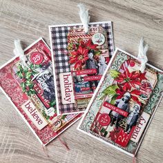 three christmas cards with poinsettis on them sitting on top of a table