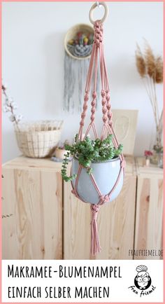 a hanging planter with plants in it and the words make me - blumenamppl