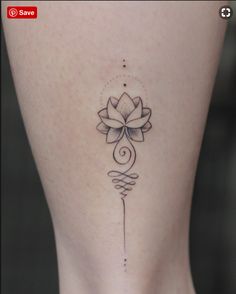 a woman's leg with a flower tattoo on the back of her thigh and an arrow in the middle