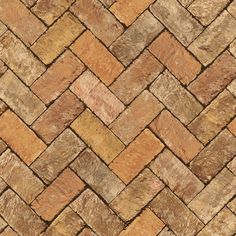 a close up view of a brick floor with brown and tan tiles on it's sides