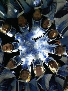 a group of cheerleaders standing in a circle