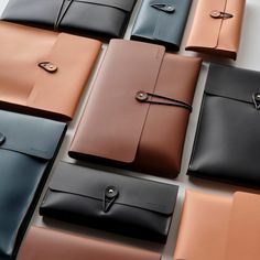 many different types of leathers are lined up on the table with one being folded