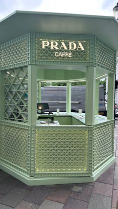 a small green booth with the word prada cafe written on it