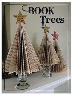 three paper christmas trees on a shelf with the words book trees written in black and white