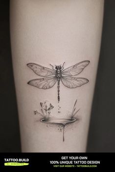 a tattoo with a dragonfly on the side of it's leg and flowers