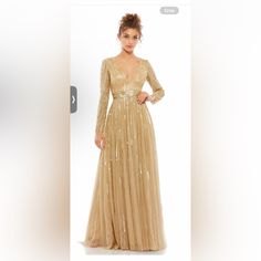 a woman in a gold dress is looking at the camera and has her hands on her hips