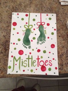 a handprinted christmas card with the words mistle toes on it