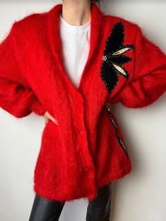 Vintage mohair wool mix cardigan in beautiful red color, with lovely leather flower embroidered patchwork on the front and the back. It has a lining inside, and shoulder padding, closure with buttons.  Material: Wool and Mohair  Vintage condition level: Good Condition  MODEL is 5.9 ft 177 cm tall usually size S  SIZE: Estimated size: S / M  Every item is vintage, pre-used, pre-loved, one-of-a-kind. All orders are final and sold as-is.  If you have any questions, please contact us before purchase. Irregularities or signs of wear might be present.  Visit our shop:  https://www.etsy.com/shop/DiscothequeClothing Let's keep in touch! Follow us on Instagram! IG: le_disc0theque https://www.instagram.com/le_disc0theque/ One Size Red Winter Cardigan, Vintage Red Cardigan For Spring, Red Vintage Cardigan For Spring, One Size Vintage Winter Cardigan, Vintage Red Sweater For Spring, Handmade Vintage Cardigan For Winter, Handmade Vintage Winter Cardigan, Handmade Red Outerwear For Fall, Handmade Red Winter Outerwear