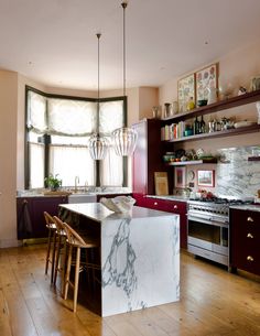 a kitchen with marble counter tops and wooden floors