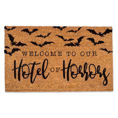 a welcome mat with bats on it that says, welcome to our hotel of horror