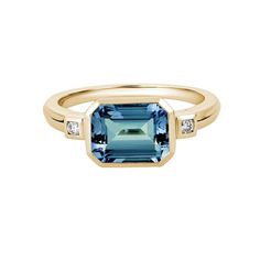 This ring features an emerald-cut London blue topaz center flanked by a diamond accent set on either shoulder in 14K yellow gold. Total diamond weight: 0.05 ct Ring size: 7.25 Blue Topaz Jewelry, Colored Stone Rings, Emerald Cut Rings, Topaz Engagement Ring, Topaz Jewelry, London Blue Topaz Ring, Swiss Blue Topaz, Yellow Gold Ring, Blue Topaz Ring