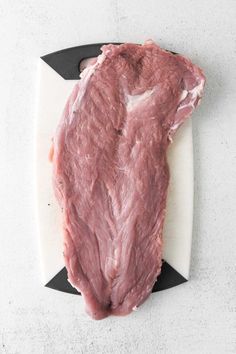 raw meat sitting on top of a cutting board