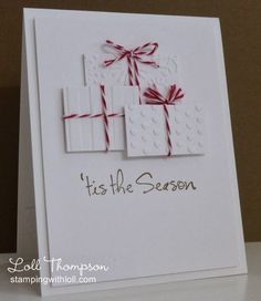 a white card with red bows and the words it's the season