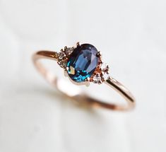 a ring with an oval blue stone surrounded by small diamonds