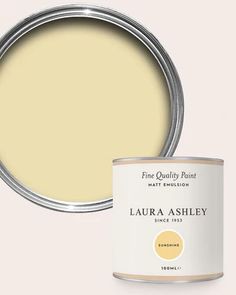 a white paint can with the lid open and it's interior painted in light yellow