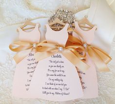 the dress is adorned with pearls and ribbon on it's hanger, along with other items