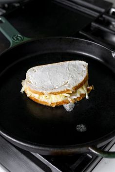 a sandwich is sitting on top of a black pan