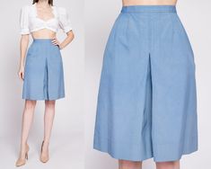 "Vintage 70s blue high waisted culotte skort. Shown clipped on model until the last two photos. Measurements and Condition:    Fits like: Small Fabric: Feels like polyester or a blend Brand: Koret of California Condition: Very good, with light general wear, and a 1/4\" faint brown spot on the middle front of the left leg.   Length: 22\" Waist: 26.5\" Hips: 39\" - taken 1\" below the bottom of the zipper opening Rise: 15\" Inseam: 8.5\"   Shown on a 5'9\" model with measurements of 33\"-24\"-37\" Retro Pleated Skirt Bottoms For Summer, Spring Skirt With Built-in Shorts, Knee-length, Fitted Knee-length Spring Culottes, Fitted Knee-length Culottes For Spring, High Waist Pleated Culottes For Summer, Vintage High Waist Shorts For Workwear, Vintage High-waist Shorts For Work, High Waist Vintage Shorts For Workwear, Retro Wide Leg Spring Shorts