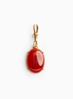 This genuine carnelian cabochon has been known to encourage creativity, courage and positive energy since the age of antiquity. Fashioned into a pendant, it may be worn at the end of a singular chain or among a collection of charms at your wrist. Materials & Dimensions Flash plated antiqued gold over brass, genuine carnelian cabochon 1.5” charm; 1” clasp Amber Carnelian Round Pendant Jewelry, Carnelian Pendant Gemstone Jewelry, Carnelian Gemstone Pendant Jewelry, Carnelian Cabochon Pendant Jewelry, Carnelian Cabochon Round Pendant Jewelry, Carnelian Gemstone Amulet Jewelry, Carnelian Gemstone Round Pendant Jewelry, Elegant Carnelian Jewelry With Large Pendant, Carnelian Gemstone Oval Pendant