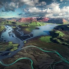 an aerial view of a river running through the mountains and lakes in iceland's faroen