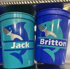 two plastic buckets with the name britton on them are sitting next to each other