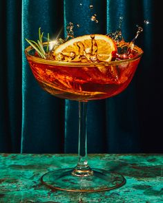 a glass filled with liquid sitting on top of a table