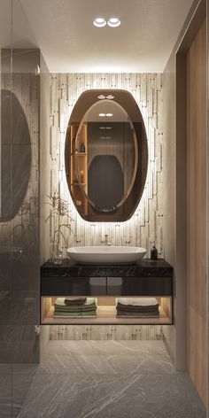 a bathroom with a round mirror above the sink