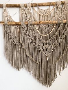 macrame wall hanging with wooden sticks and beads