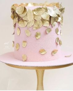 a pink hat with gold leaves on it