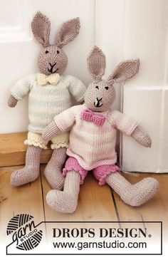 two knitted rabbits sitting next to each other in front of a door with the words drops design on it