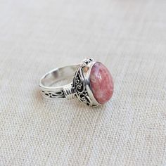 Gemstone - RhodochrositeGemstone Size - 12x16 oval Metal - Sterling SilverRing Size - All sizes AvailableNatural pink rhodochrosite sterling silver handmade ringRhodochrosite attracts love by opening up the heart chakras with its healing vibrations. It gives us the inner strength to take another chance at love because even if you fall, the Rhodochrosite crystal will always catch you.The ring can be customized on request and gemstone can be switched to any gemstone you want. Feel free to contact Pink Oval Gemstones For Gift, Pink Oval Gemstones For Gifts, Pink Oval Spiritual Ring, Oval Cabochon Crystal Ring As Gift, Oval Natural Stones Jewelry For Wedding, Moonstone Ring With Large Oval Stone For Gift, Oval Cabochon Large Stone Jewelry Gift, Oval Cabochon Jewelry With Large Stone For Gift, Handmade Oval Crystal Ring As Gift