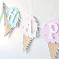 an ice cream cone banner with the letter p on it, hanging from a wall