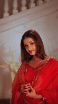 a woman in a red dress posing for the camera