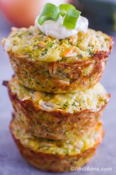 some food is stacked on top of each other with sour cream and scallions