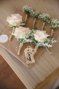 the wedding table is decorated with flowers and greenery on it's placemats