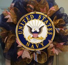 the united states navy wreath is hanging on the door