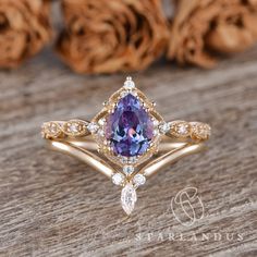 a tan gold ring with a purple stone surrounded by diamonds