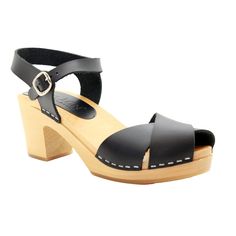 The Duve from BJORK by KLAGN Swedish Comfort is a hand-made open back, closed toe wooden clog sandal in premium black leather. * Hand Made in Europe * Soft Leather * Adjustable strap * 2.75" / 70mm heel and .75" / 20mm platform * Genuine European wood outsole with rocker bottom to propel the foot forward * Outsole wood harvested from sustainable European forests ---> Ships in 1 business day ---Sizing Conversion EU     US Women's 35      5 36  5.5 - 6 37  6.5 38  7 - 7.5 39  8 - 8.5 40  9 - 9.5 4 Black Mules With Wooden Heel And Ankle Strap, Black Clogs With Ankle Strap And Leather Sole, Black Ankle Strap Clogs With Leather Sole, Slingback Black Clogs With Buckle Closure, Black Leather Clogs With Ankle Strap, Black Slingback Clogs With Buckle Closure, Black Closed Toe Clogs With Heel Strap, Black Open Heel Clogs For Summer, Black Clogs With Heel Strap And Block Heel